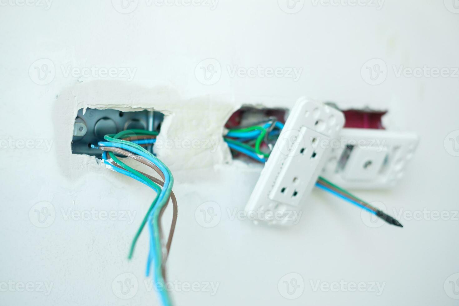 Electrical Wiring under plaster, hidden installation cables for socket to a concrete. Renovation, Repair and development of home and apartment concepts photo