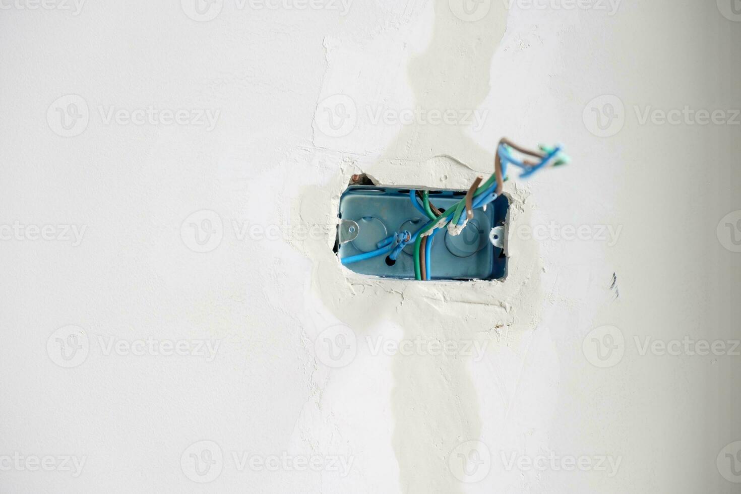 Electrical Wiring under plaster, hidden installation cables for socket to a concrete. Renovation, Repair and development of home and apartment concepts photo