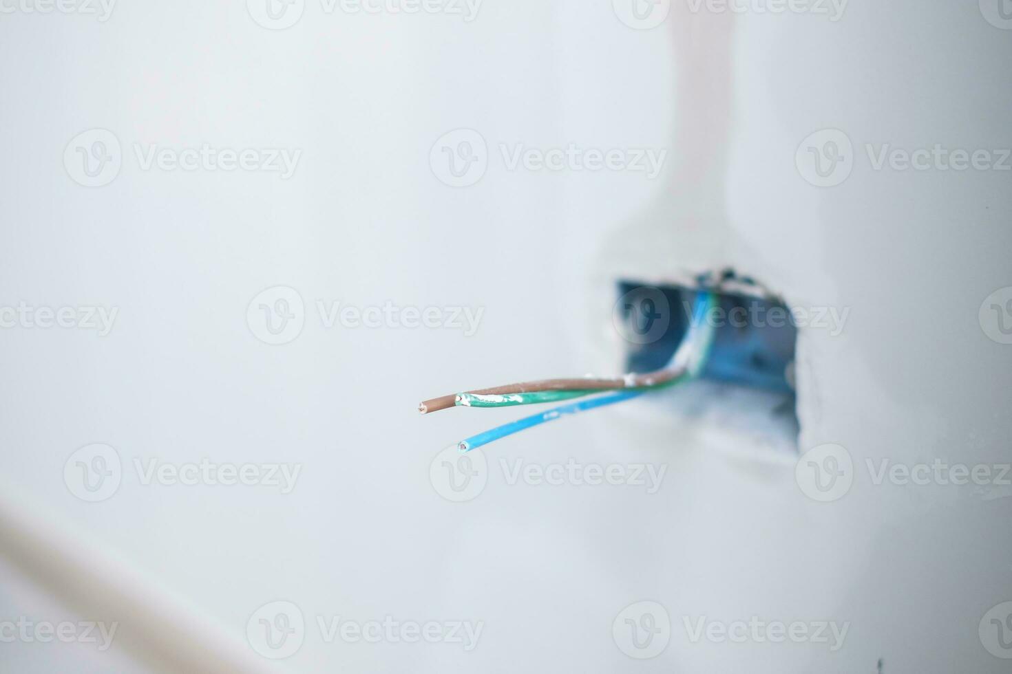 Electrical Wiring under plaster, hidden installation cables for socket to a concrete. Renovation, Repair and development of home and apartment concepts photo