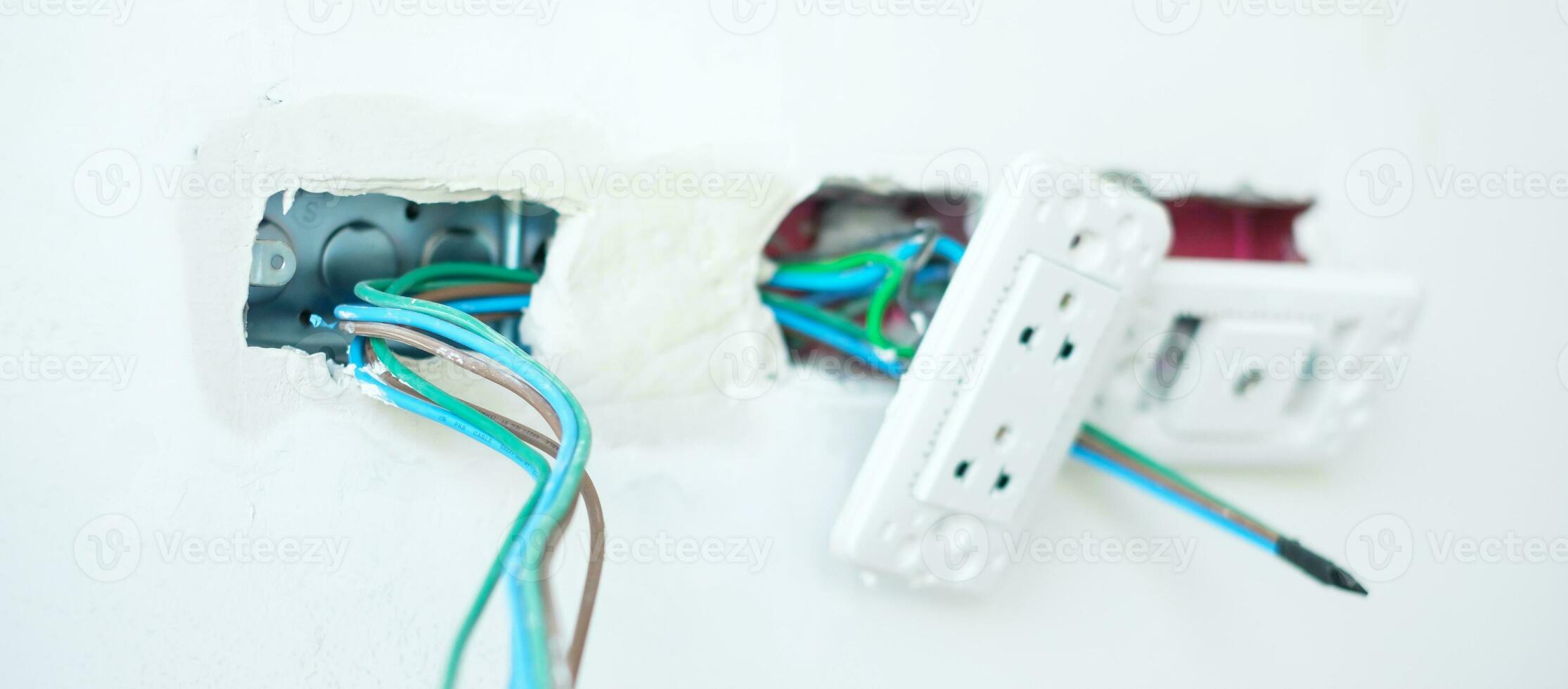 Electrical Wiring under plaster, hidden installation cables for socket to a concrete. Renovation, Repair and development of home and apartment concepts photo