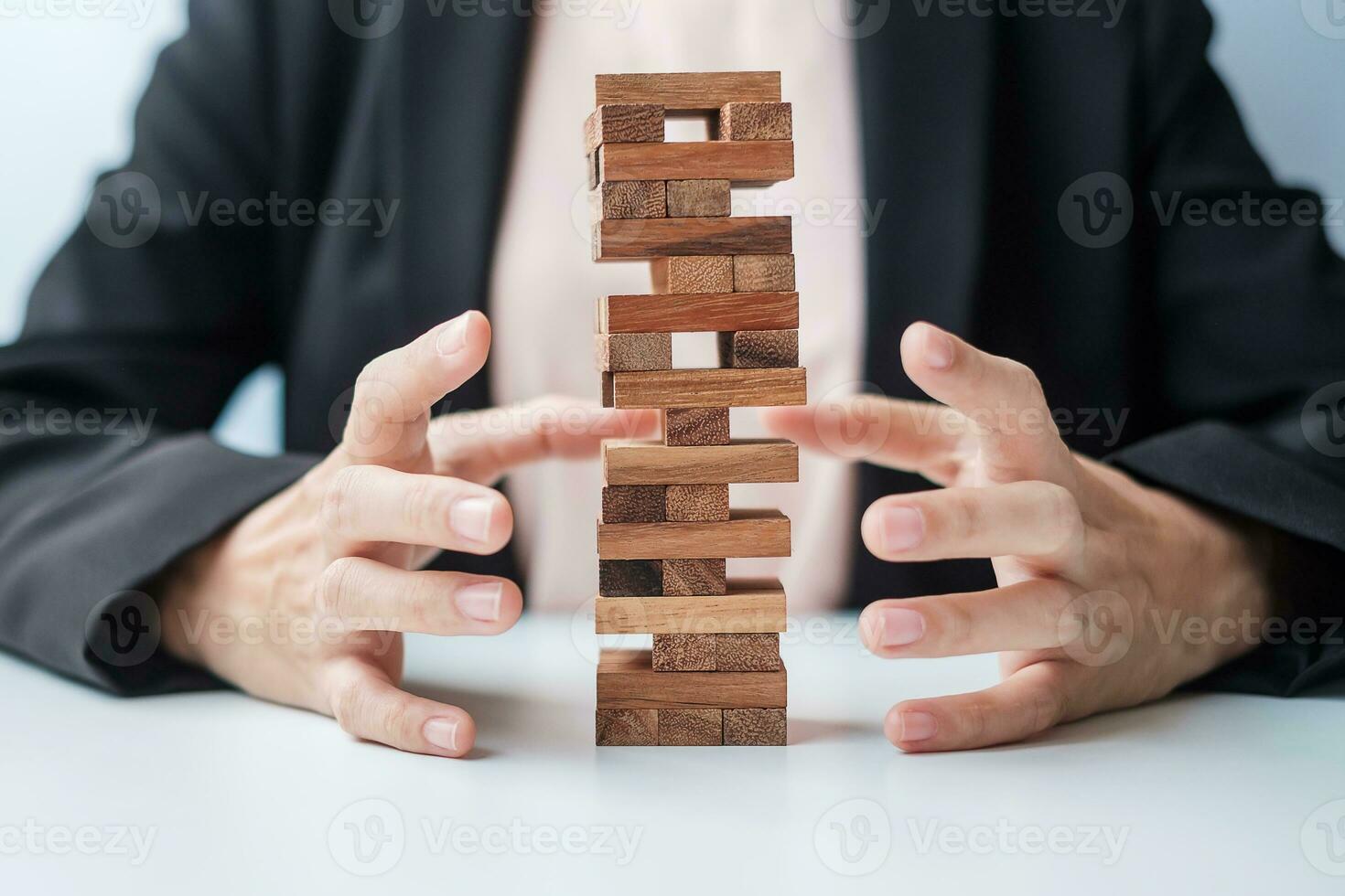 Businesswoman hand cover wooden block on the tower. Business planning, Risk Management, Solution, insurance and strategy Concepts photo