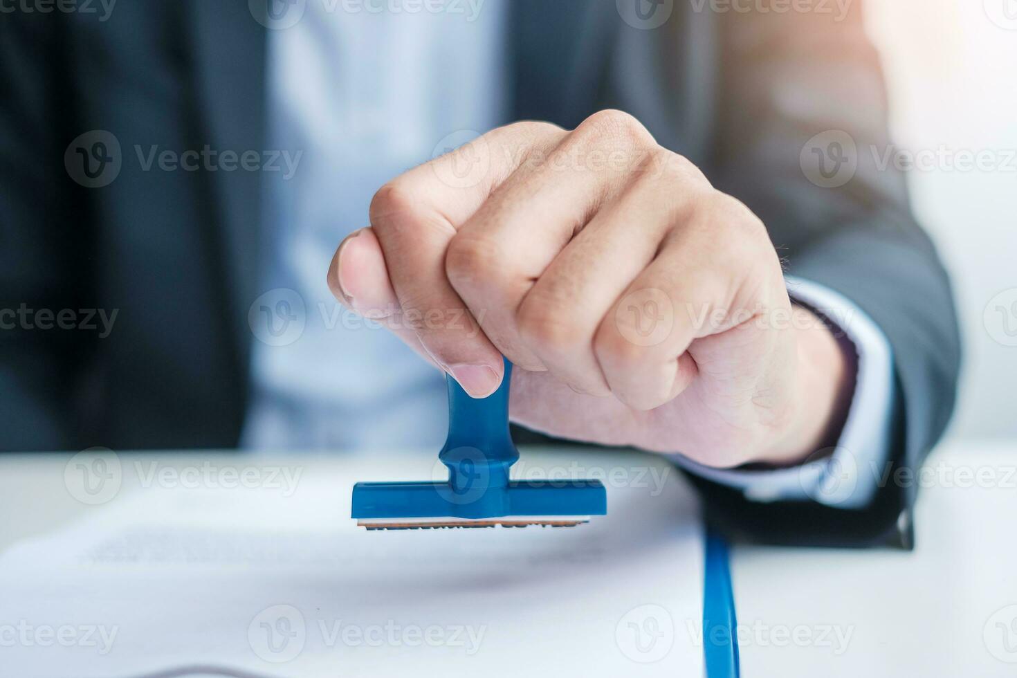 Businessman stamp during signing contract document.Business contract, approve, partnership, contract agreement and quality assurance concepts photo