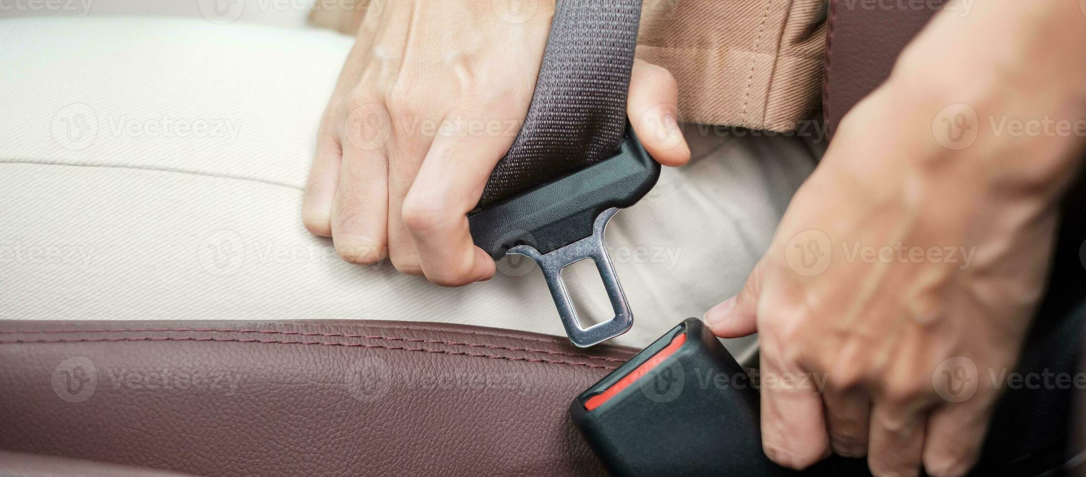 woman driver hand fastening seat belt during sitting inside a car and driving in the road. safety, trip, journey and transport concept photo