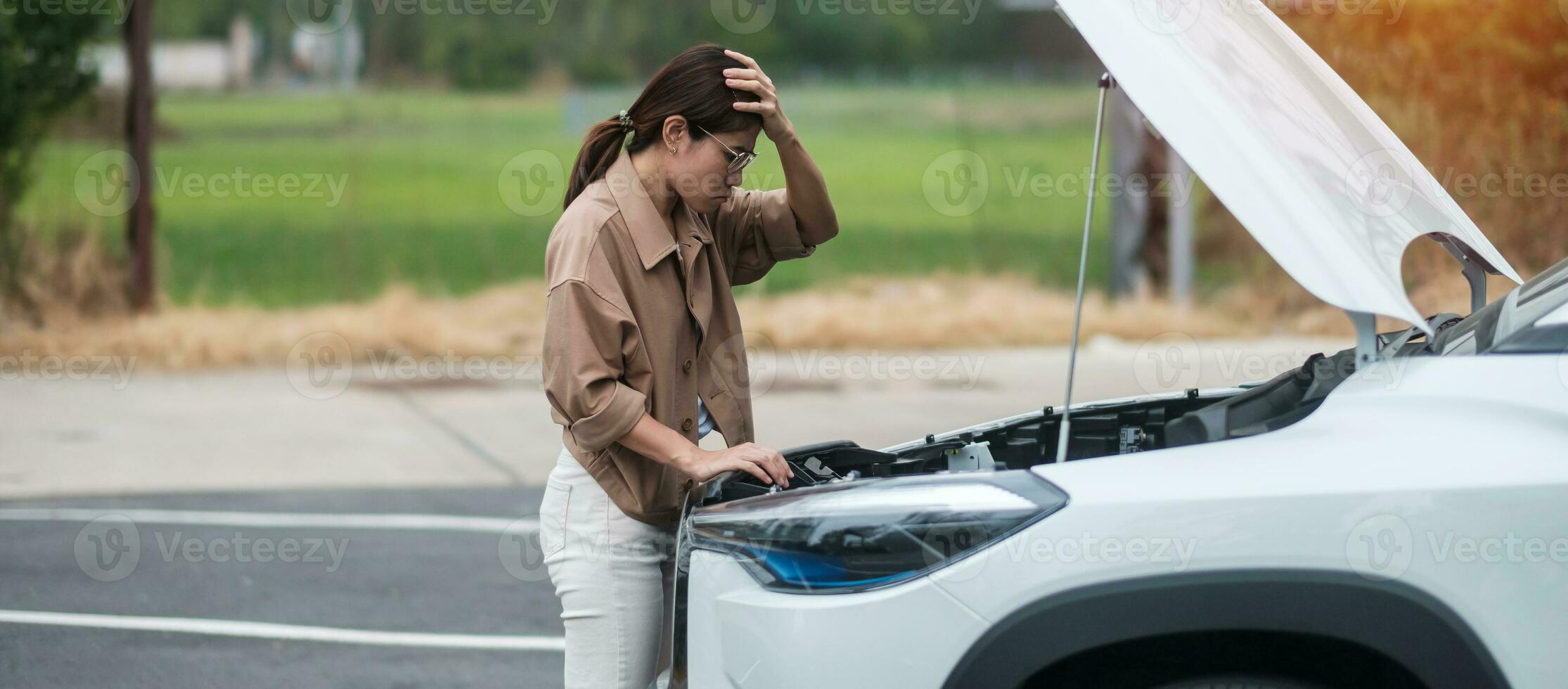 woman driver standing near a problem car. Breakdown or broken car on road. Vehicle Insurance, maintenance and service concept photo