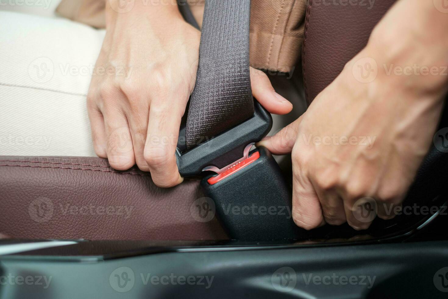 woman driver hand fastening seat belt during sitting inside a car and driving in the road. safety, trip, journey and transport concept photo