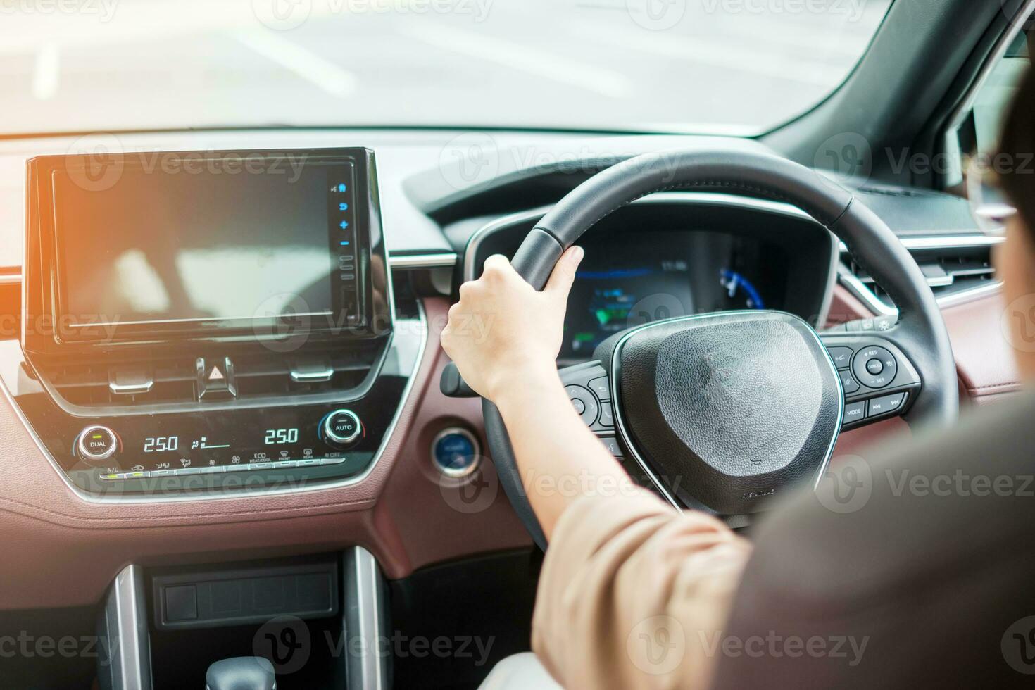 woman driver driving a car on the road, hand controlling steering wheel in electric modern automobile. Journey, trip and safety Transportation concepts photo