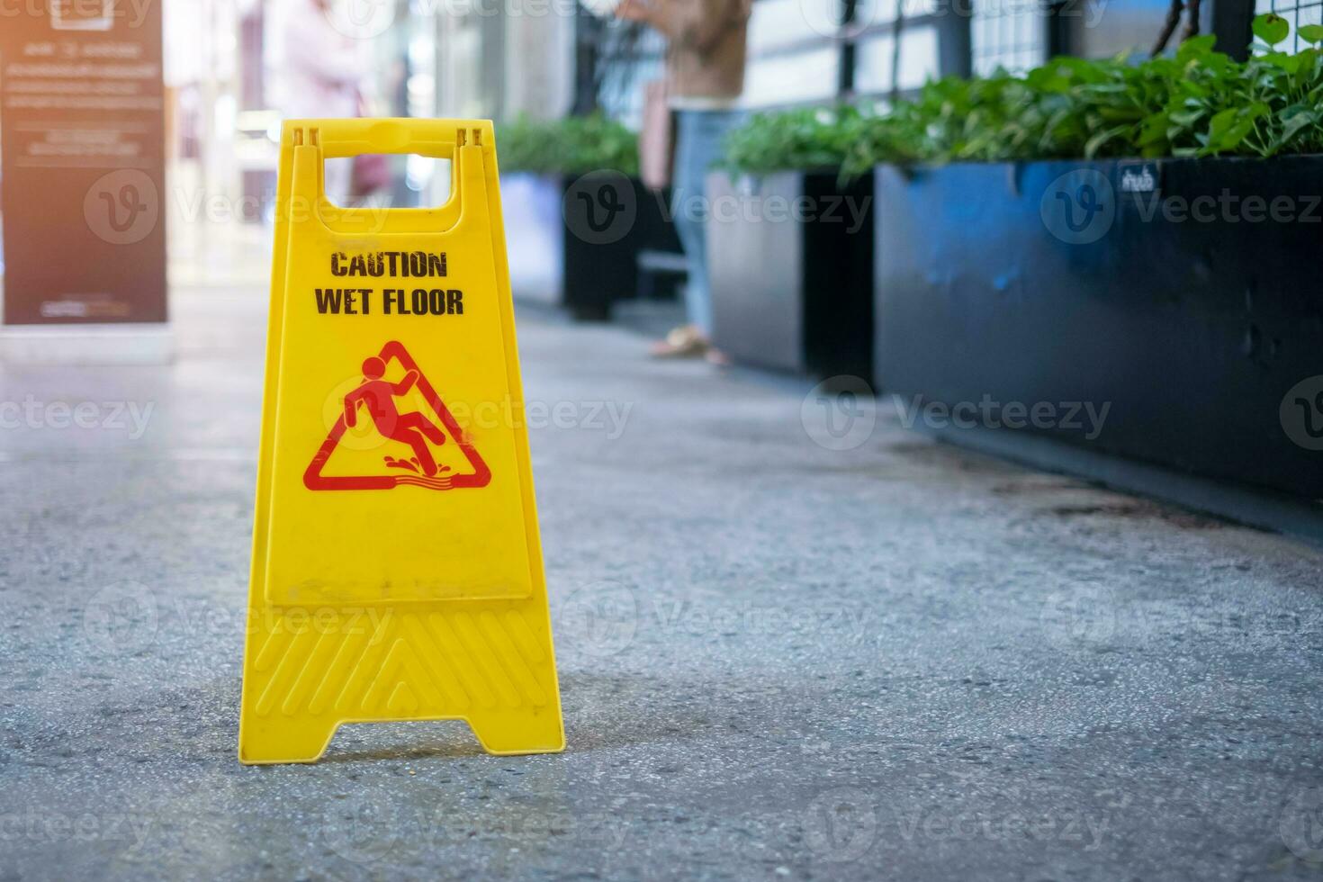 Sign showing warning of caution wet floor in office building photo