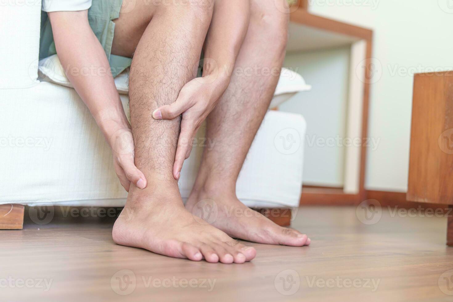 Man having leg pain due to Ankle Sprains or Achilles Tendonitis and Shin Splints ache. injuries, health and medical concept photo