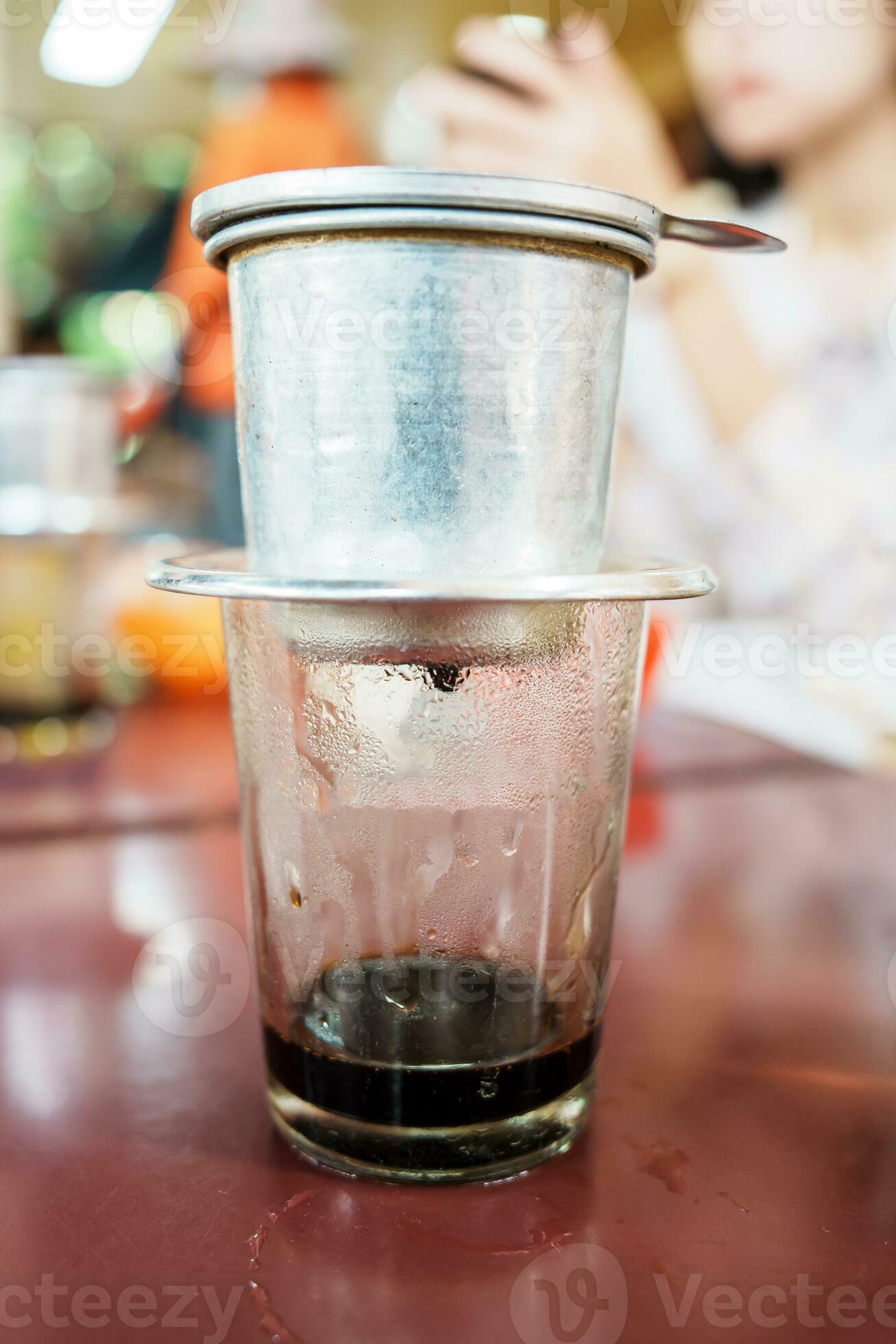 https://static.vecteezy.com/system/resources/previews/025/499/474/large_2x/vietnamese-coffee-in-glass-cups-traditional-metal-coffee-maker-phin-black-drip-coffee-as-famous-in-vietnam-photo.jpg