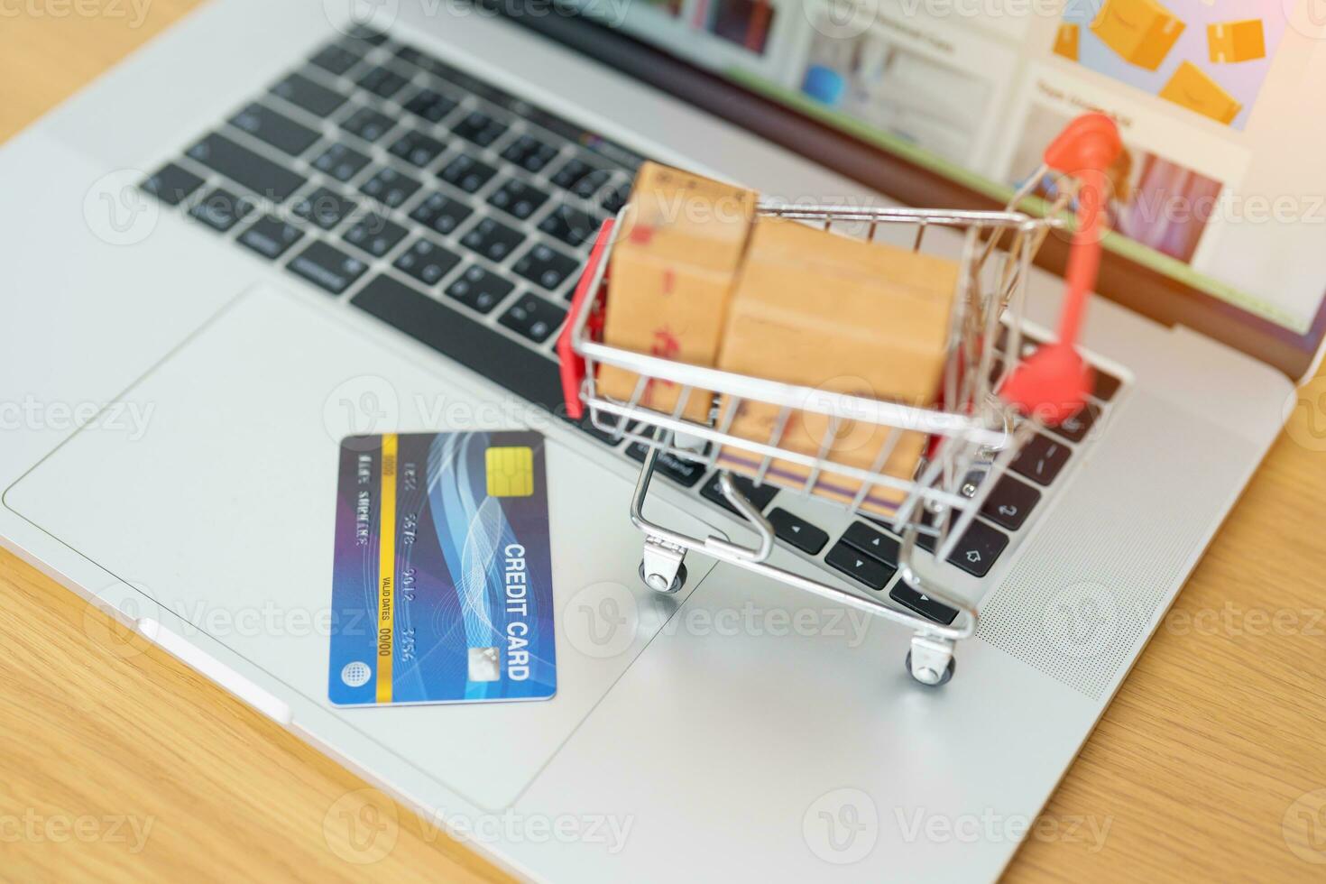 Boxes with credit card on a laptop computer. online shopping, Marketplace platform website, technology, ecommerce, shipping delivery, logistics and online payment concepts photo