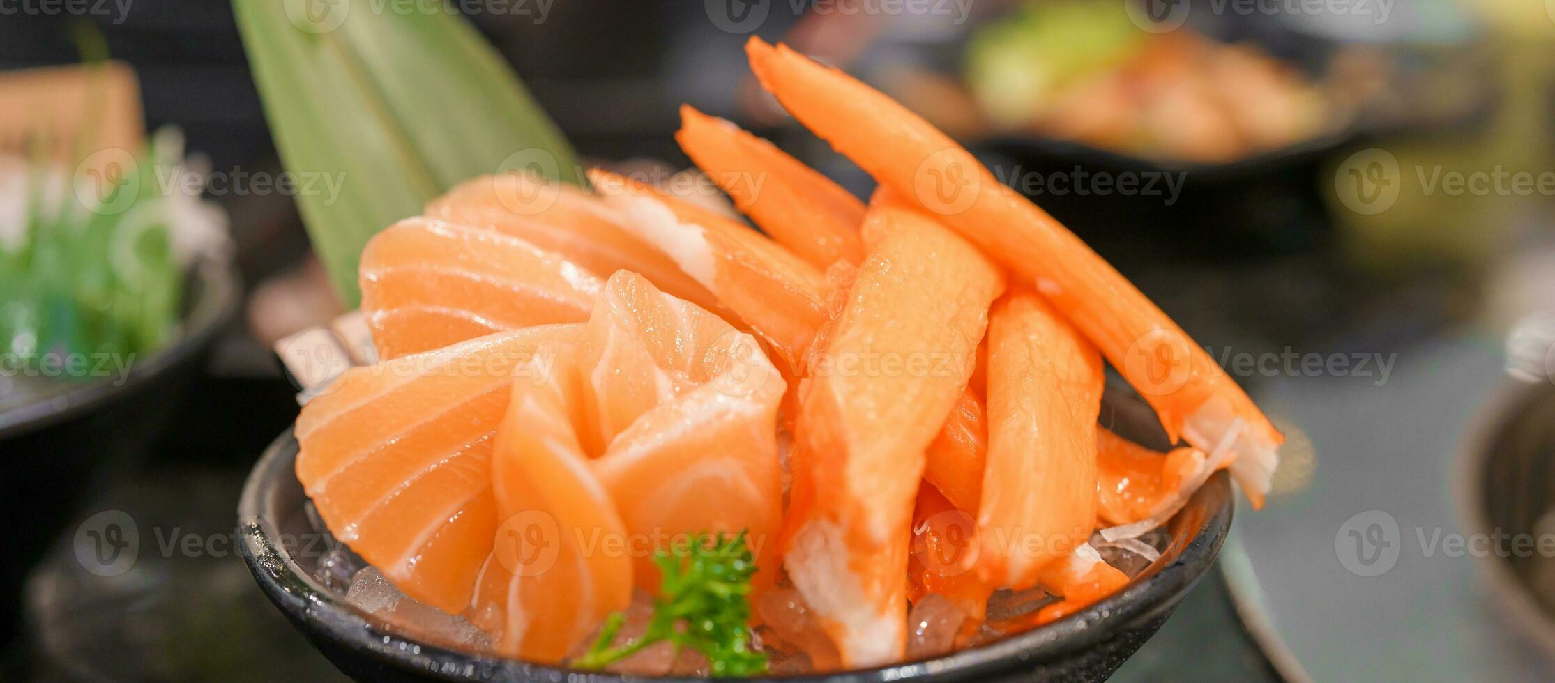 Fresh Japanese Sashimi set in Asian restaurant, orange Salmon and tuna sashimi fish on dish with ice. Japan food concept photo
