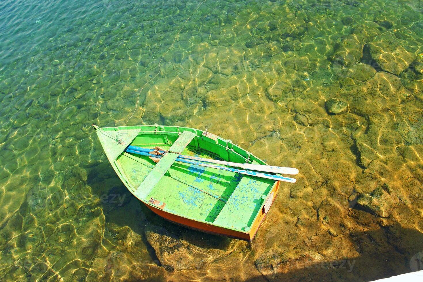 view of the wooden small boats standing in the harbor on the Spanish island of Lanzarote in the city of Arrcecife photo