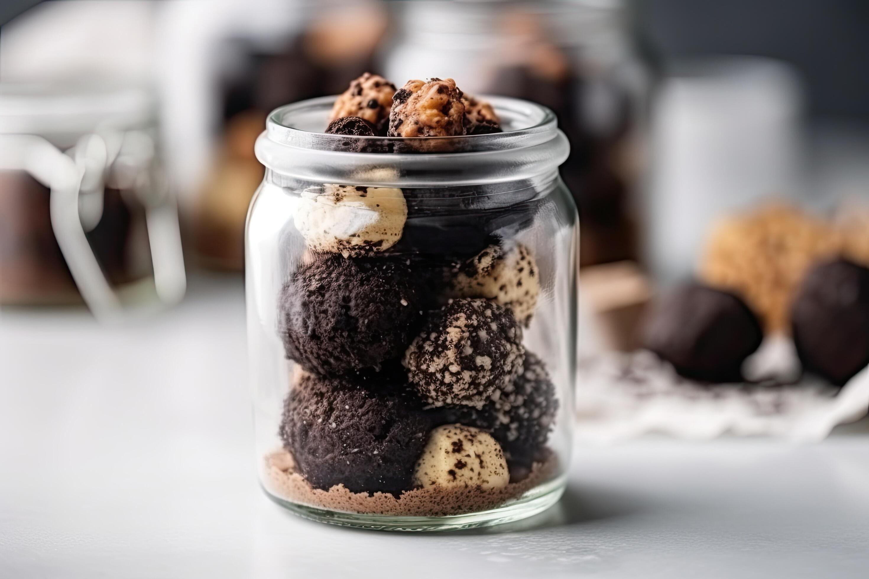 Chocolate truffles in a glass jar on a gray background, Delicious