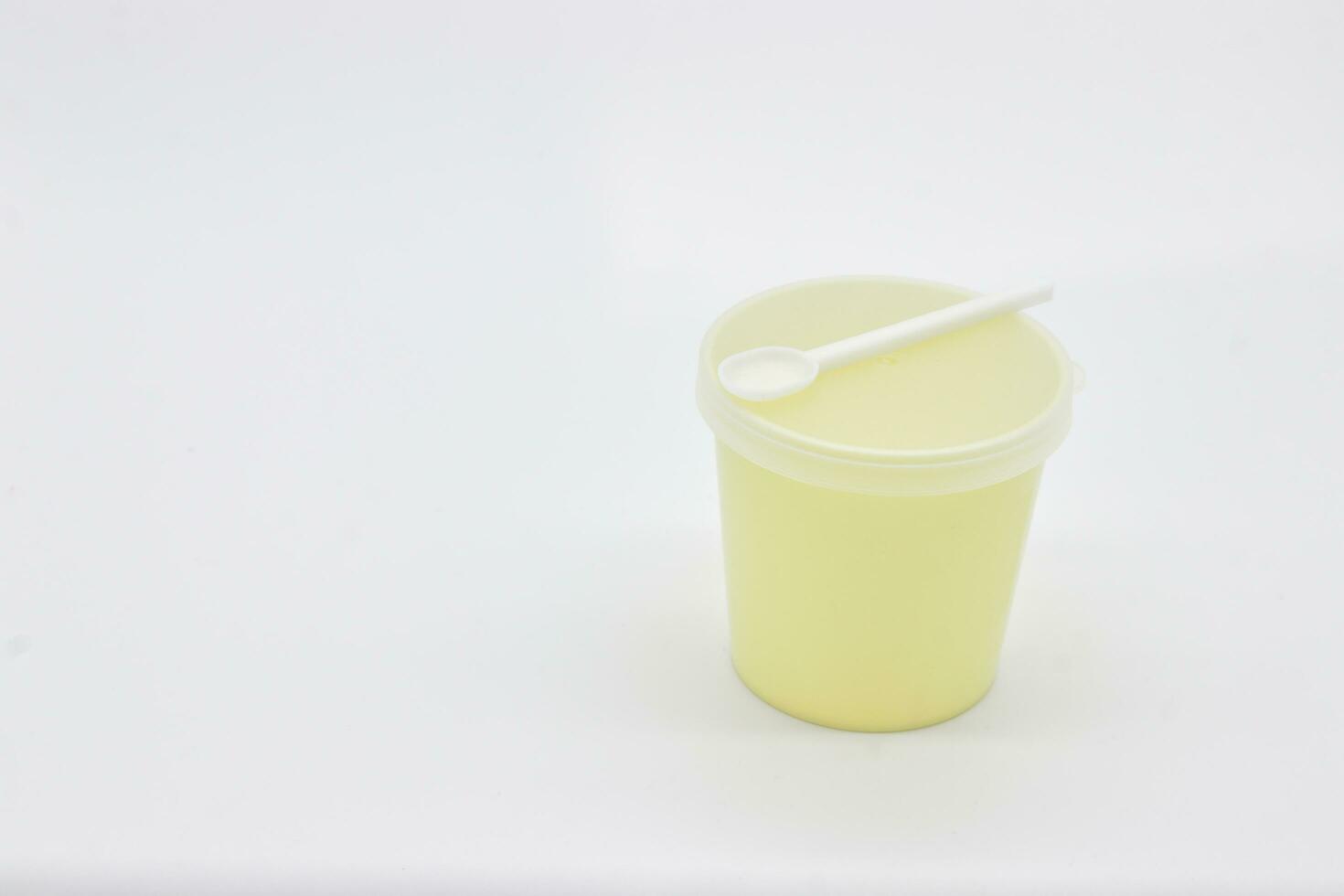 Stool test container with scoop on white background photo