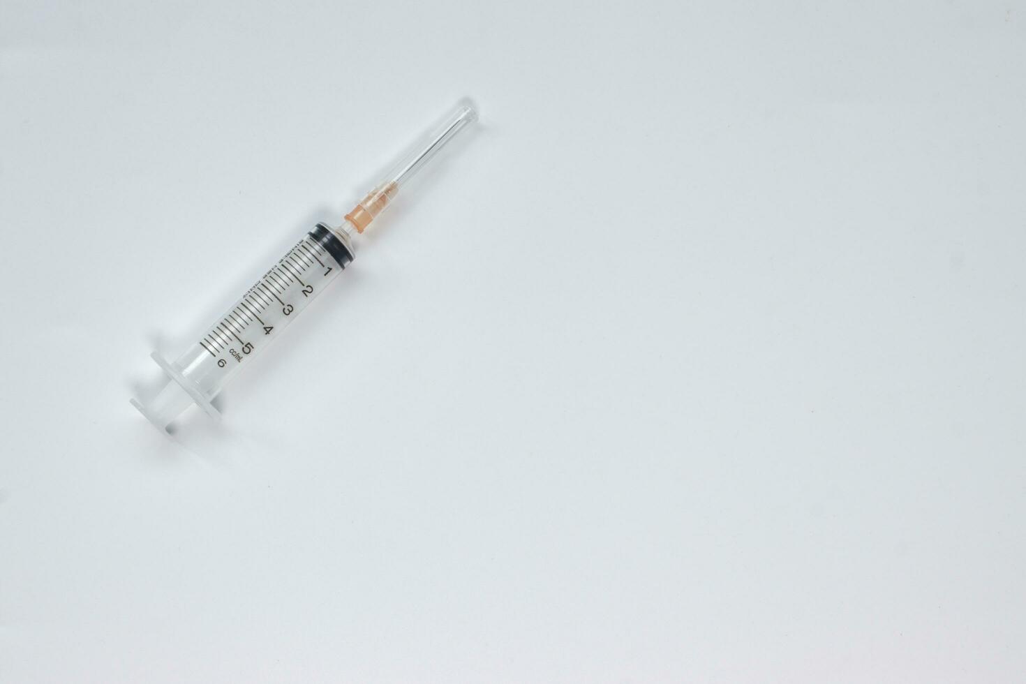 Syringe 5 ml with needle on white background, top veiw. photo