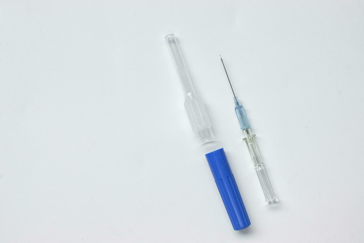 IV catheter with a needle sheath placed on white background. photo