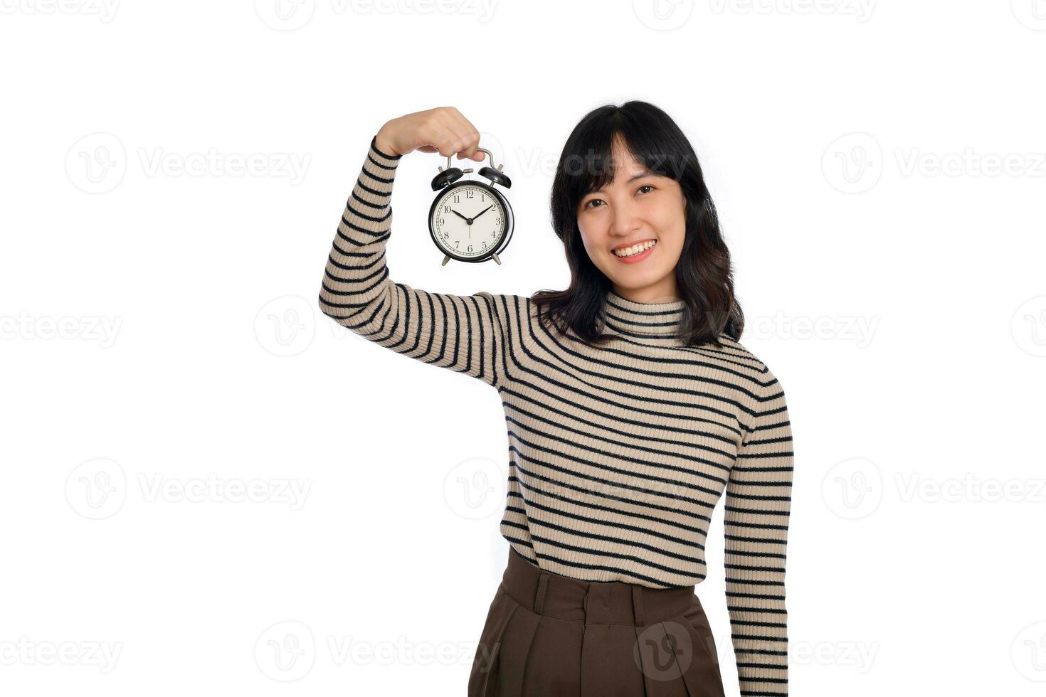 Happy Asian woman with casual clothing holding alarm clock isolated on white background photo