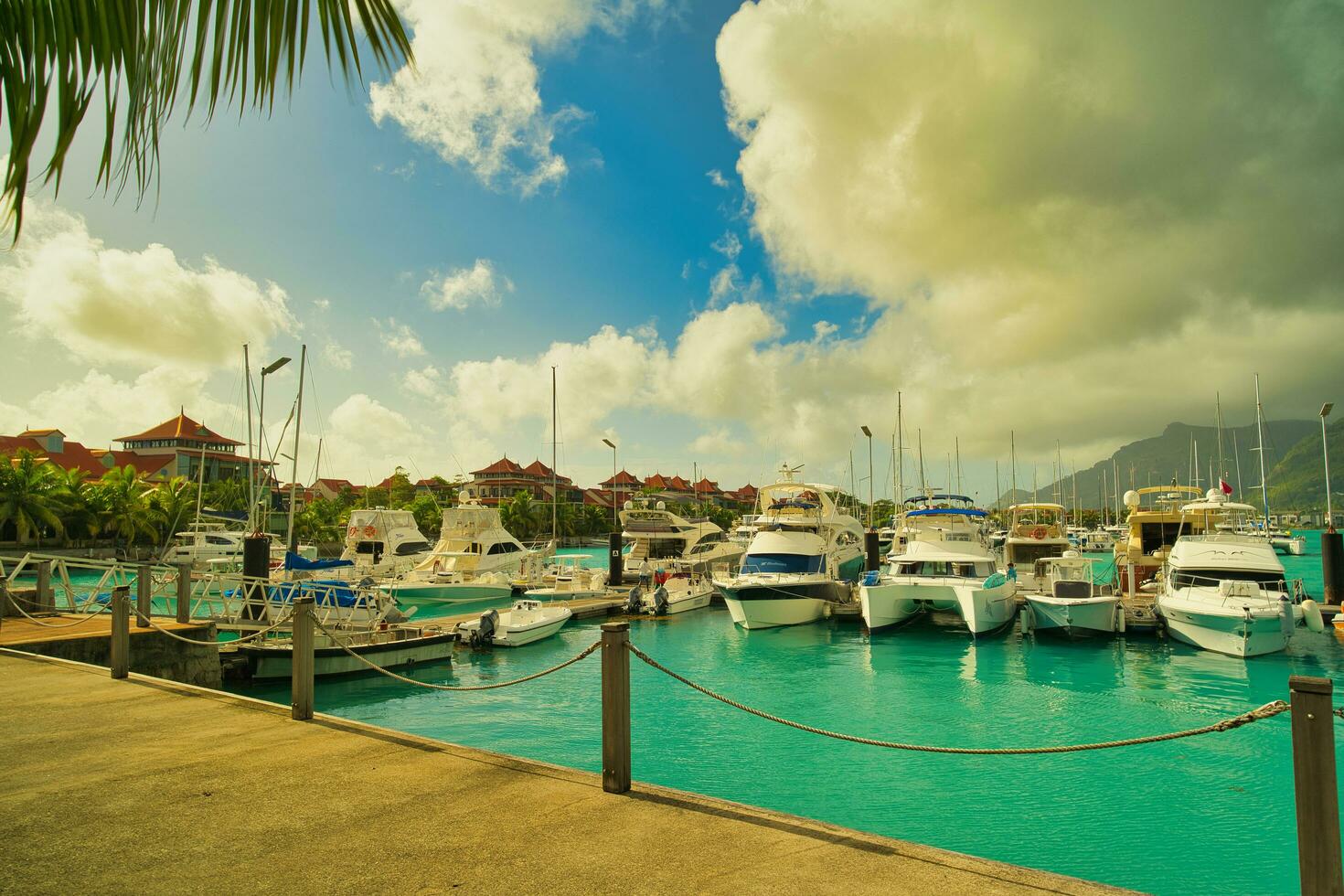 Mahe Seychelles 30.06.2023 Docking yachts and boats at eden island marina with villas at the back, view of Mahe island, lush mountain, Seychelles photo