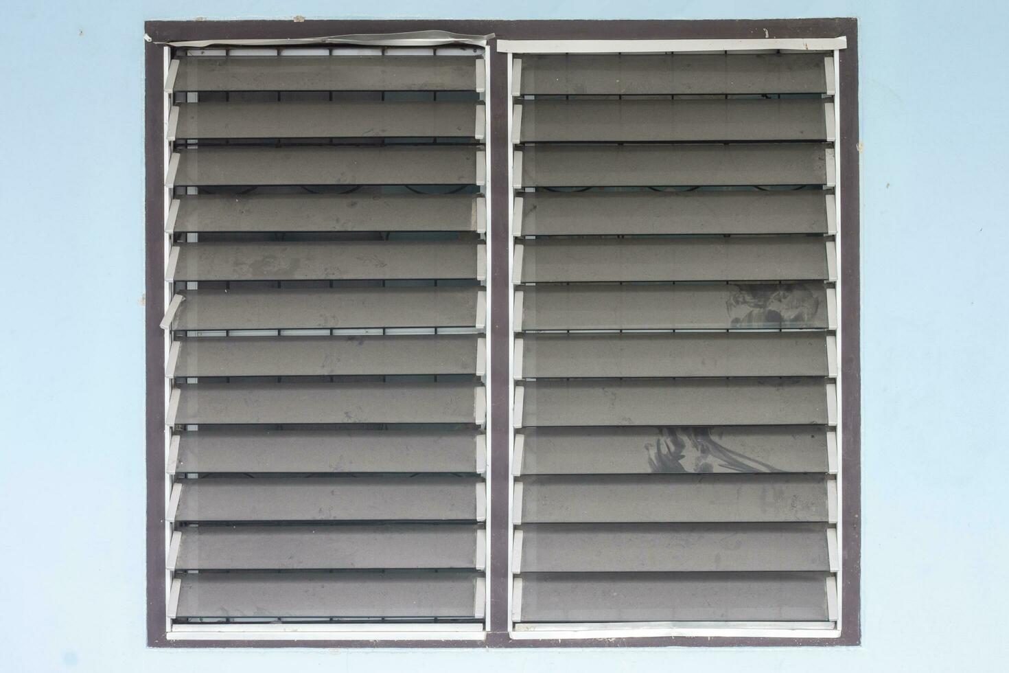 Dust clinging on a louver window that have never been cleaned affecting the health of residents. photo