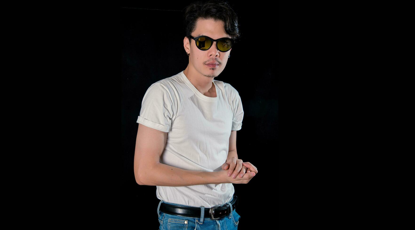 Portrait of men with sunglasses standing looking camera  on dark studio background , asian photo