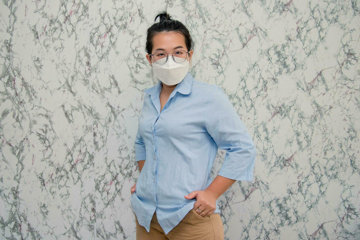 elegant womanman wearing a mouth protection to prevent getting sick at work or on the way to work  isolated on White background, pandemic and social distancing concept.Covid-19 photo