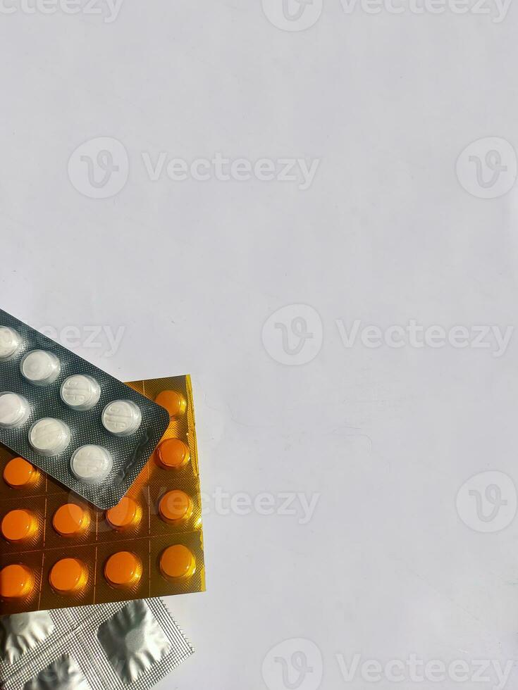 Unwrapped tablet shape background of tuberculosis drugs and vitamins, with blank space for content requirements photo