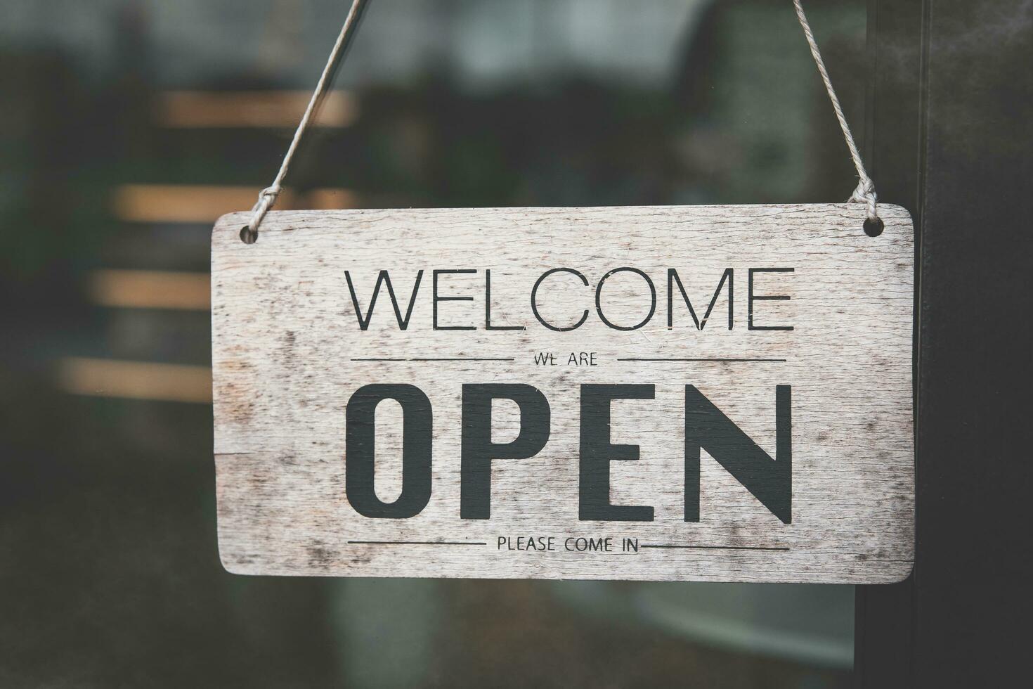 sign informing customers of cafes on holidays. Open sign on the glass door of the restaurant. service business idea open everyday photo