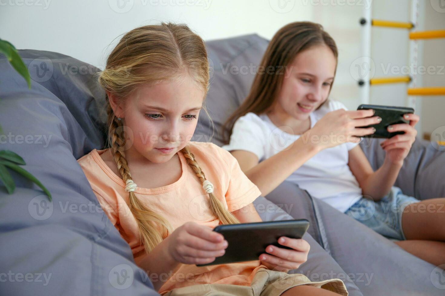 Children play with a mobile phone at home photo