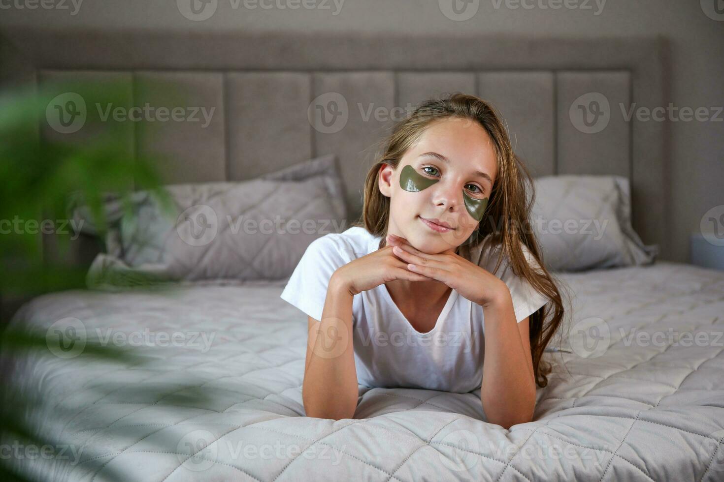 Beautiful girl with hydrogel patches under the eyes photo