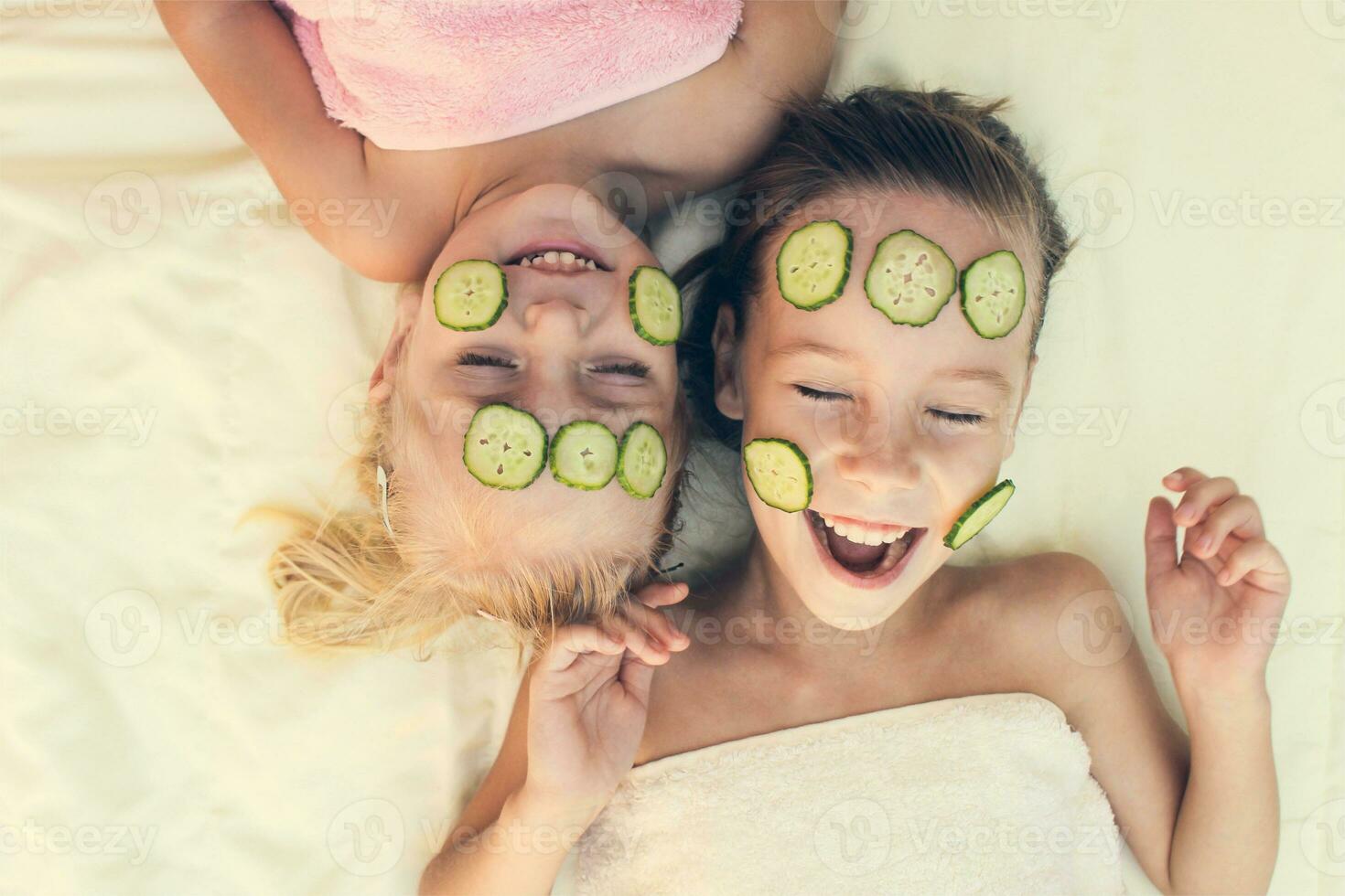 Beautiful girl with facial mask of cucumber. Toned image photo