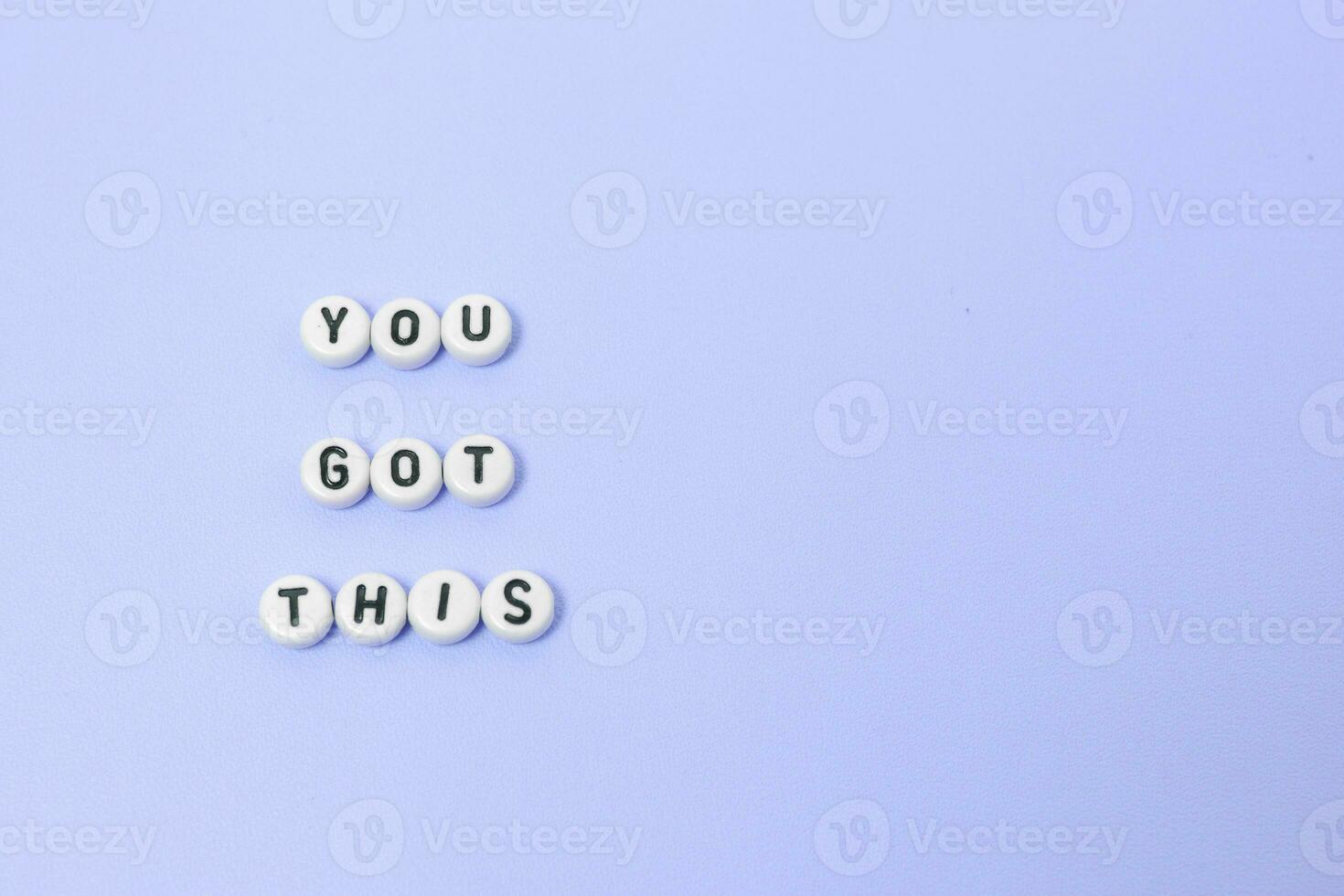 Top view of you got this quotes made out of beads on pastel background. motivation and success concept photo