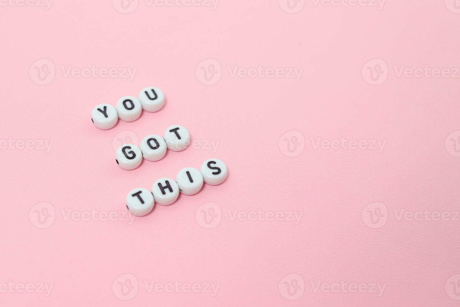 Top view of you got this quotes made out of beads on pastel background. motivation and success concept photo