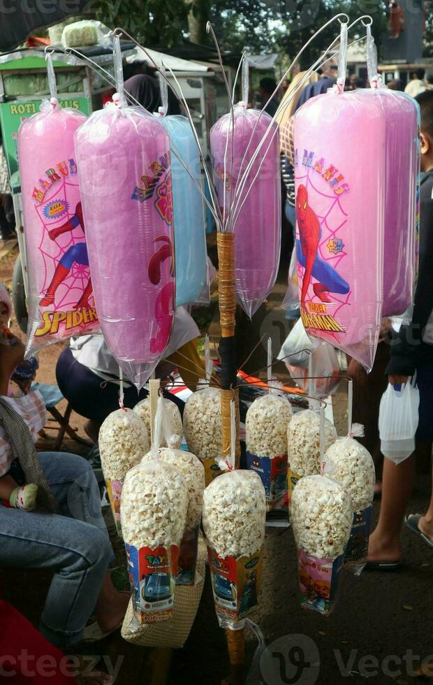 Colorful cotton candy in plastic cup photo