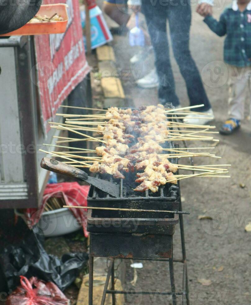 Grilling Sate Ayam  Chicken satay photo