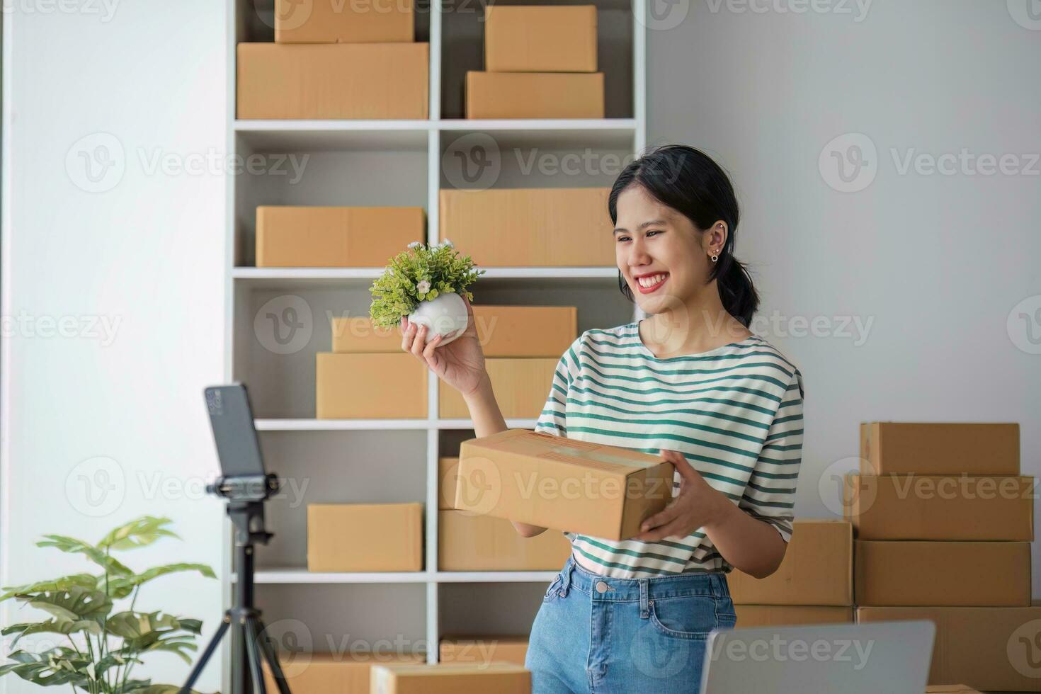 Starting Small business entrepreneur SME freelance, Portrait young woman working at home office, BOX, smartphone, laptop, online, marketing, packaging, delivery, b2b, SME, e-commerce concept. photo