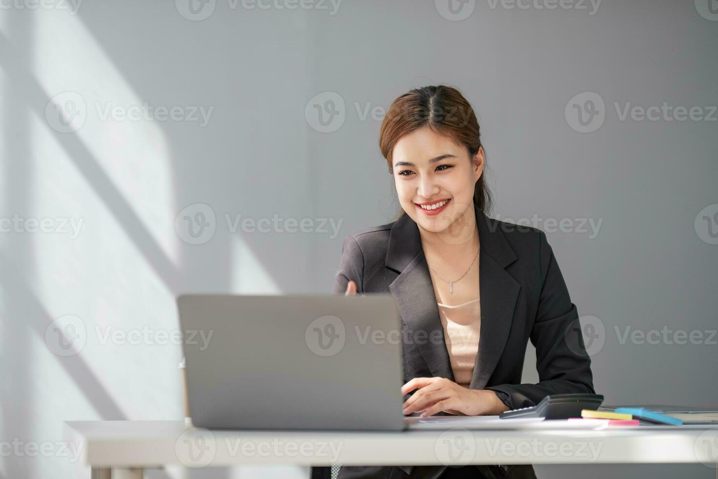 Business woman using calculator for do math finance on wooden desk in office and business working background, tax, accounting, statistics and analytic research concept photo