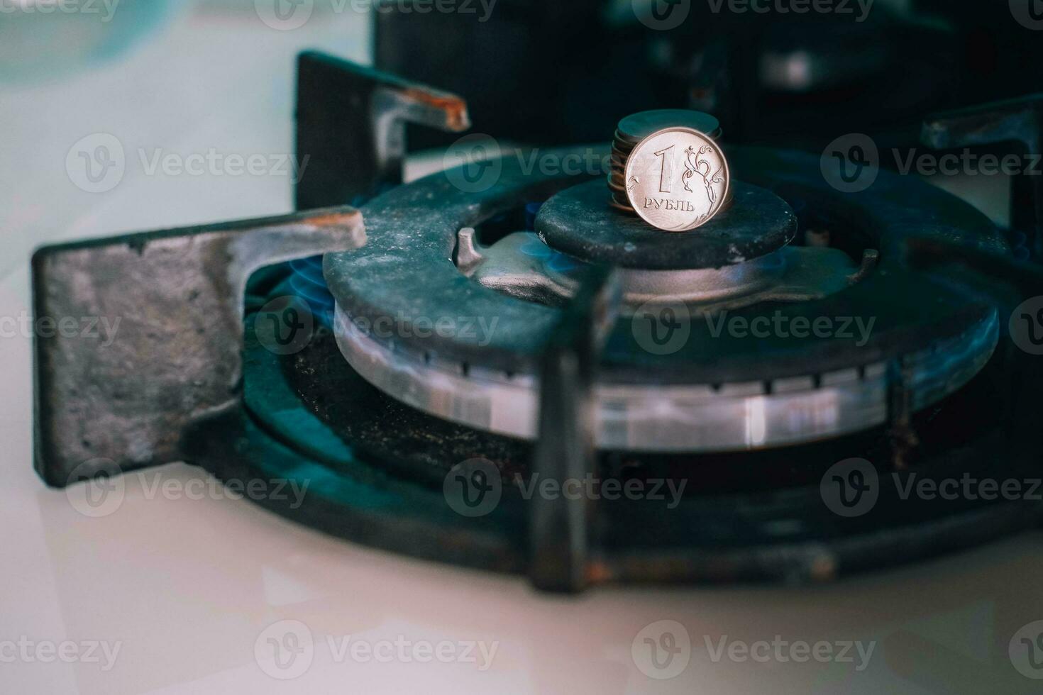 Gas burner and ruble coin, Russian money on home gas stove. Blue propane gas flame and ruble currency. Concept of Russia and Europe economy, natural gas cost, inflation, sanctions and payment. photo