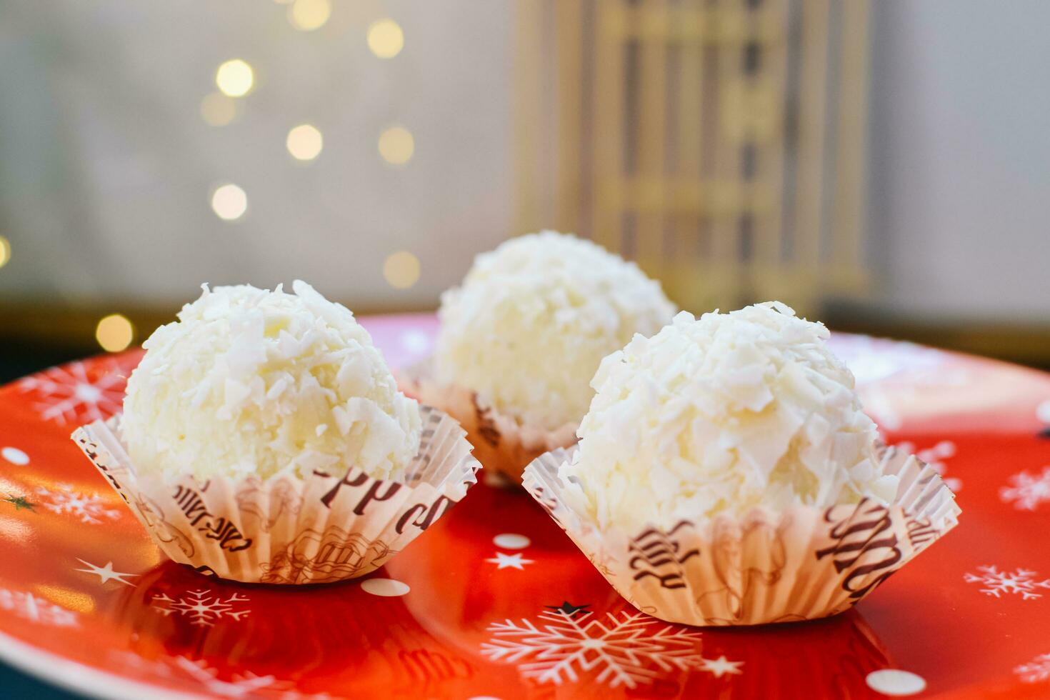 Homemade Raffaello and New Year's mood on a plate. concept of the new year photo