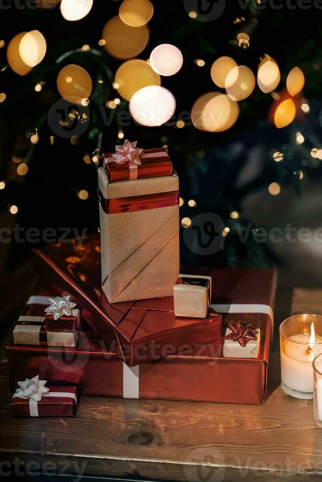 Gifts on the background of a Christmas tree with a bokeh. photo