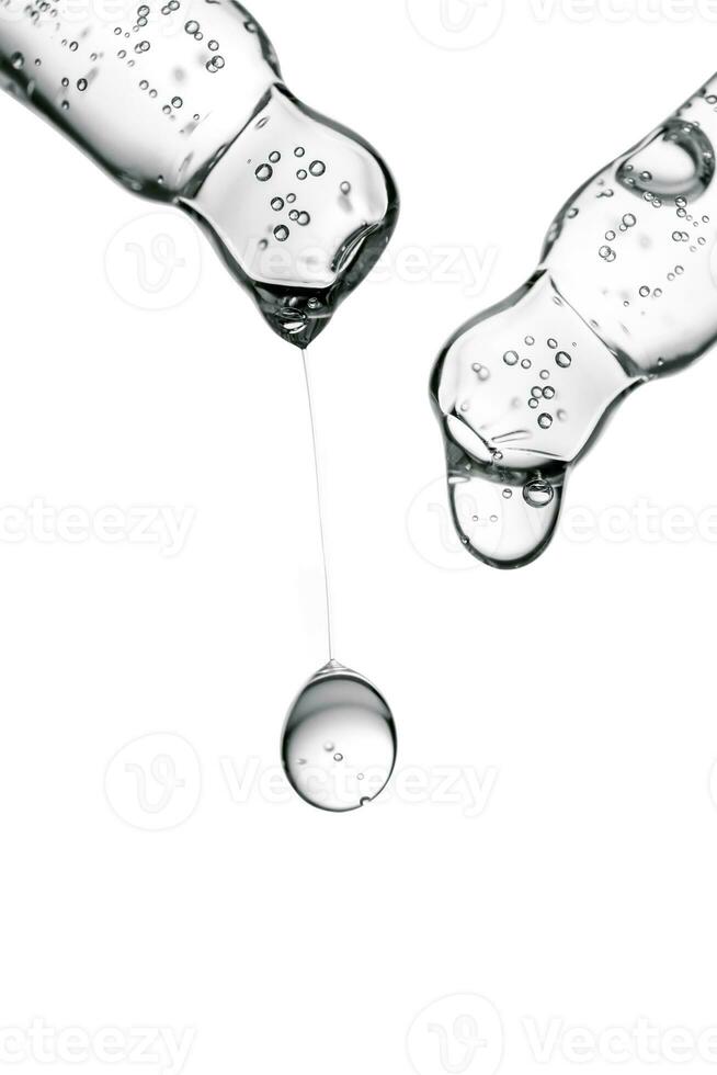 Transparent pipettes with cosmetics on a white isolated background. photo