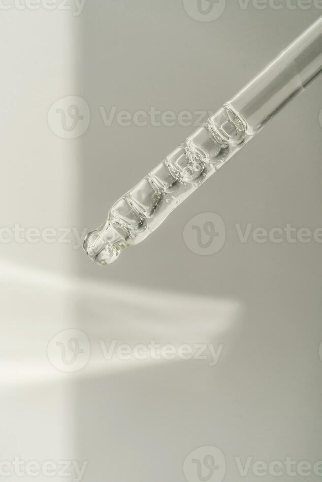 Pipette with bubbles on a white background. photo