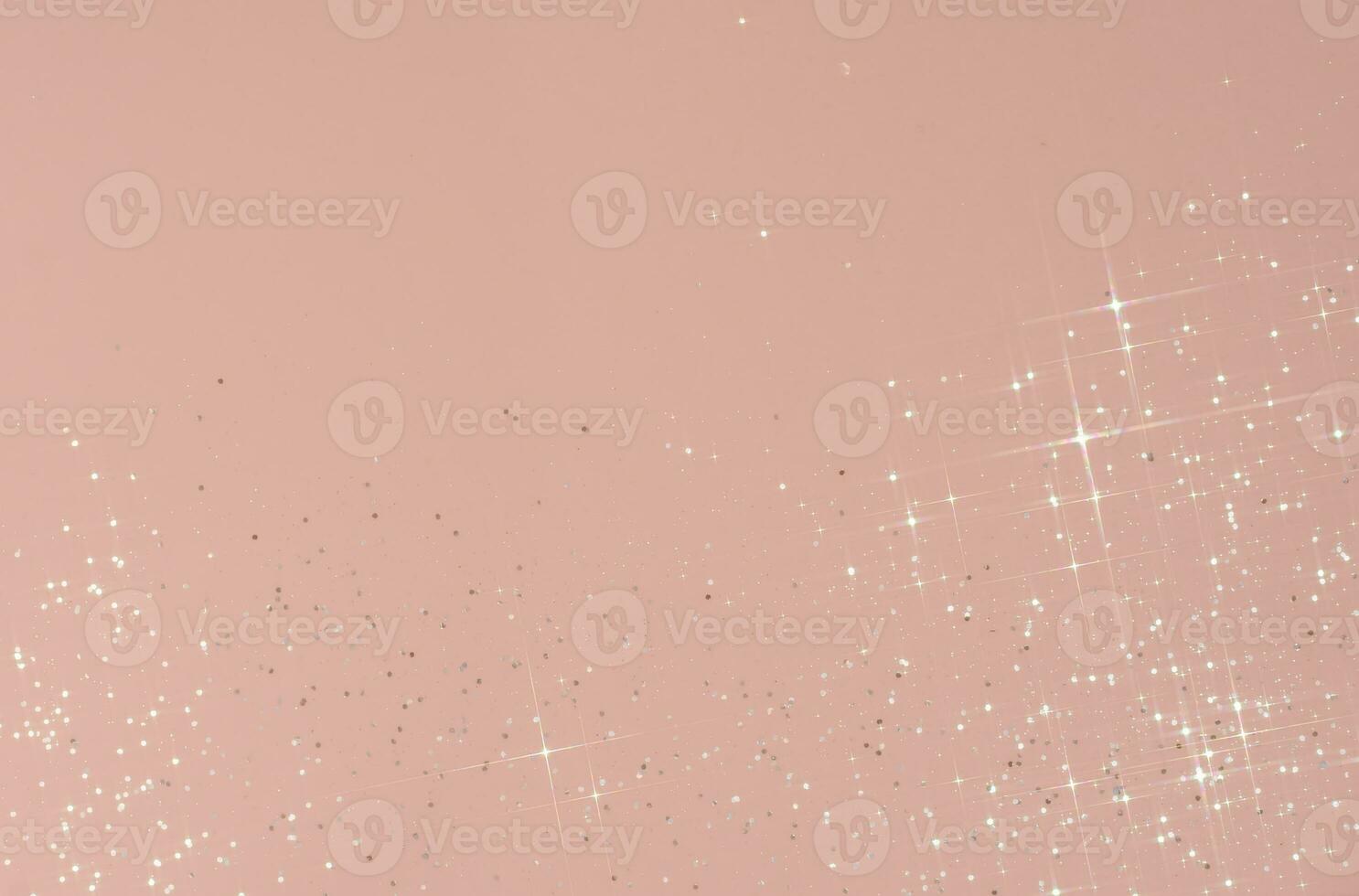 Abstract pink background with sparkles in the shape of stars. photo