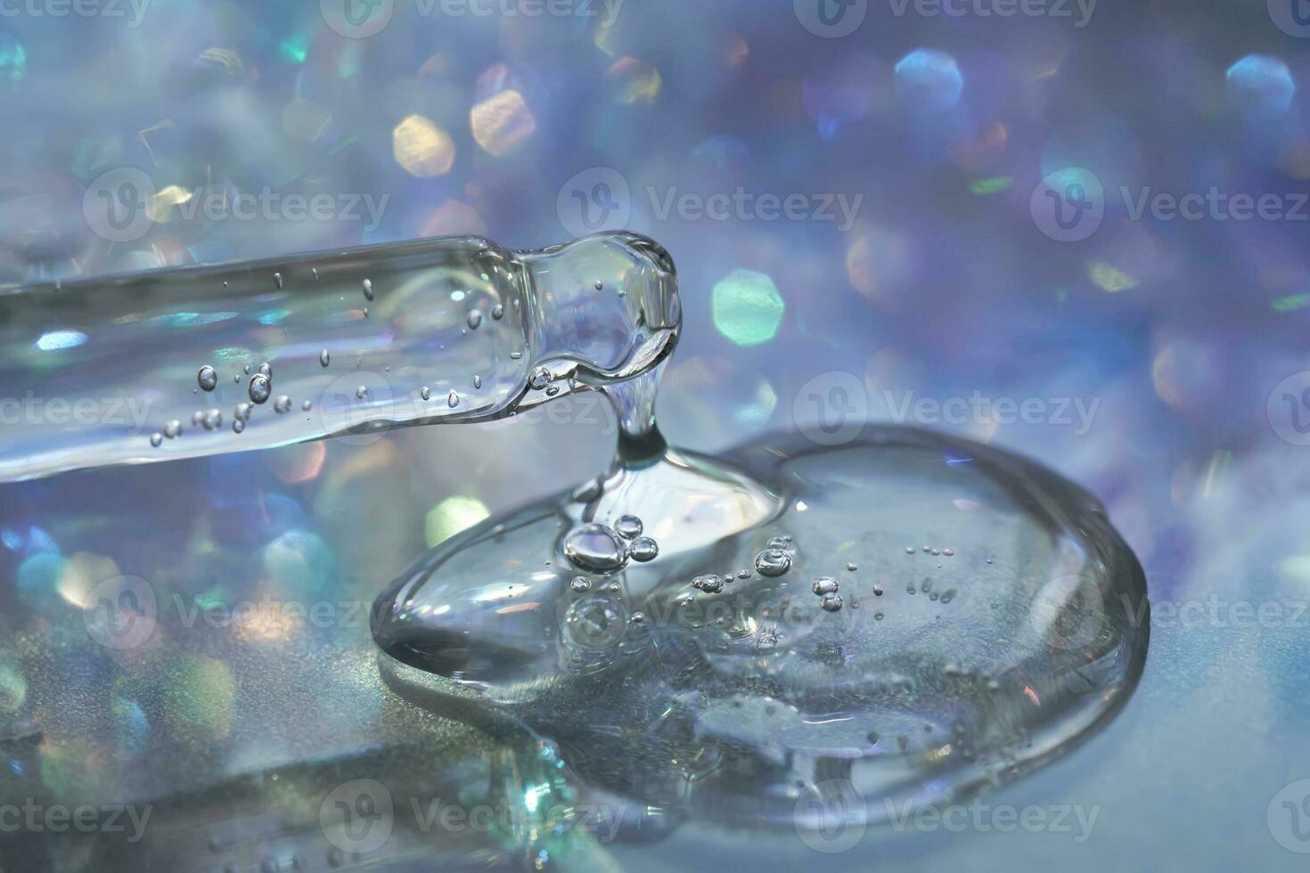 A pipette with a drop of serum in a Christmas theme . photo