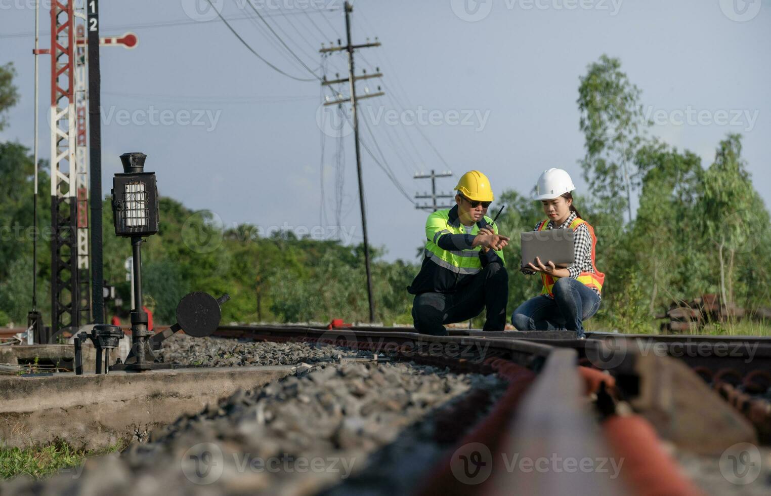 Asian railway engineer inspects a train station Engineer working on maintenance inspection in railway station photo