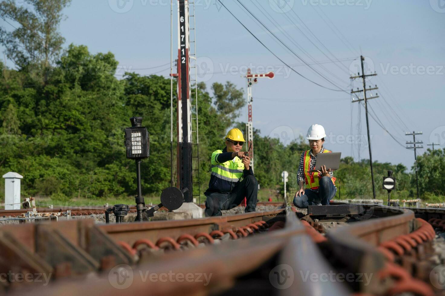 Asian railway engineer inspects a train station Engineer working on maintenance inspection in railway station photo