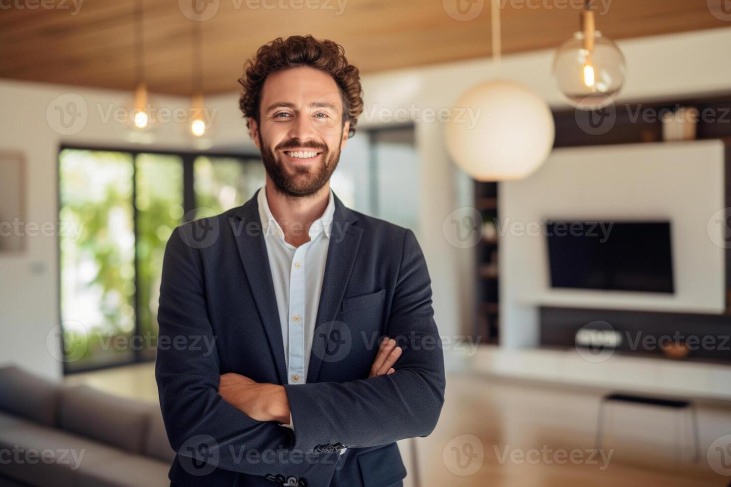 smiling male Real Estate Agent in a suit stands in new home with photo