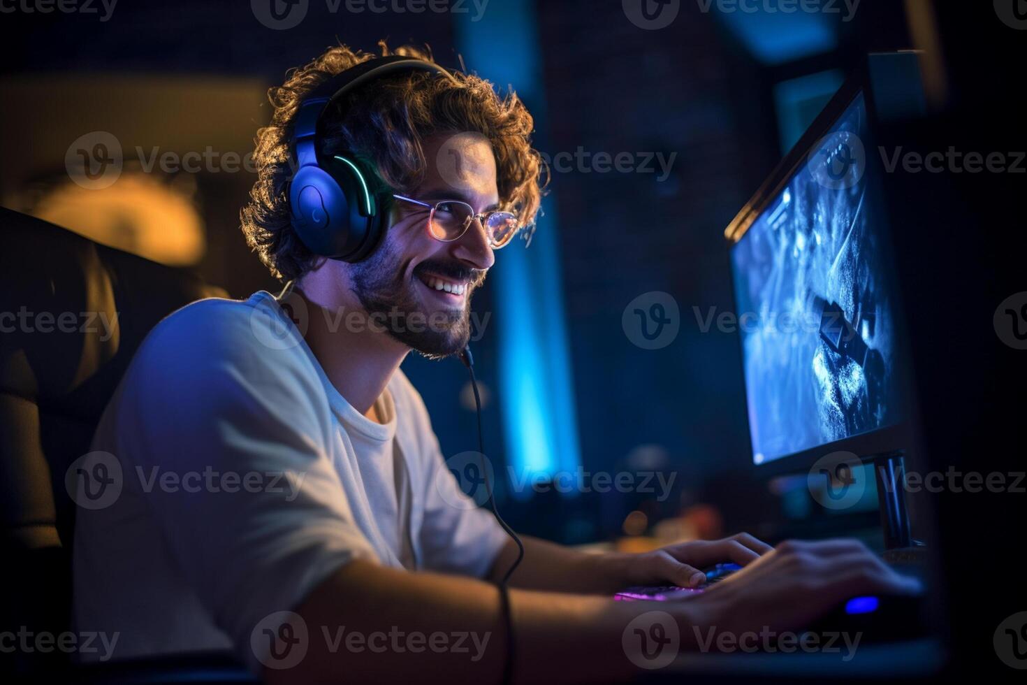 a happy gamer man wearing headphones is using a computer at night with photo