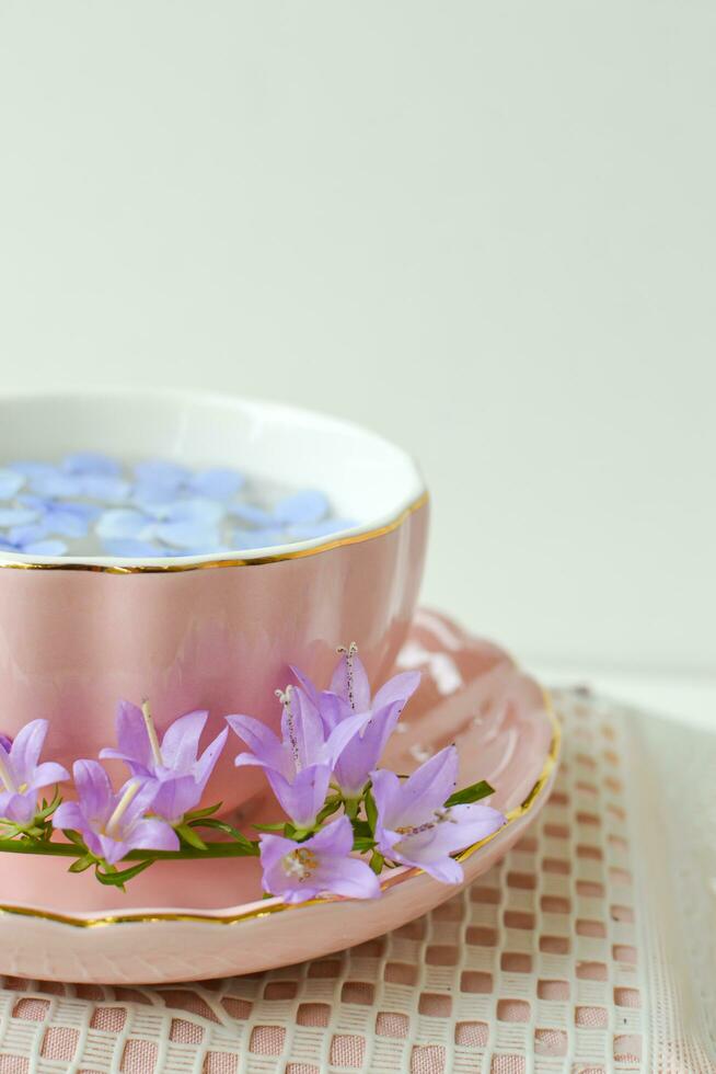 wild flowers in the pink cup for tea time and beautiful background photo