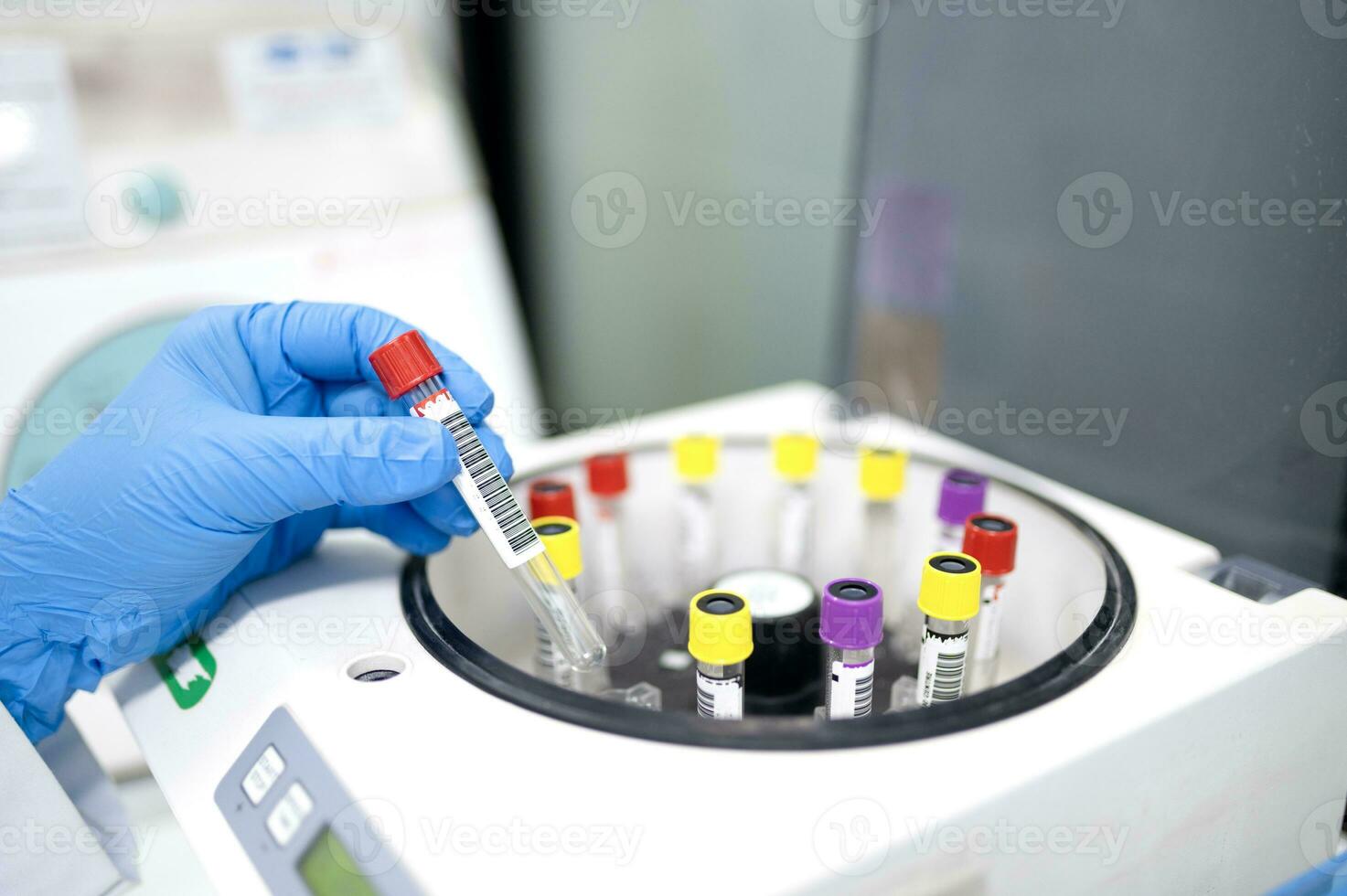 Container for tubes of biochemical analyzers Doctor removes from lab centrifuge Zika virus ZIKV photo