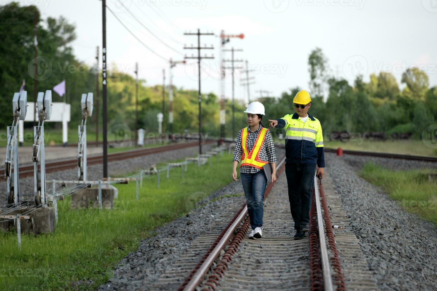 Asian railway engineer inspects a train station Engineer working on maintenance inspection in railway station photo